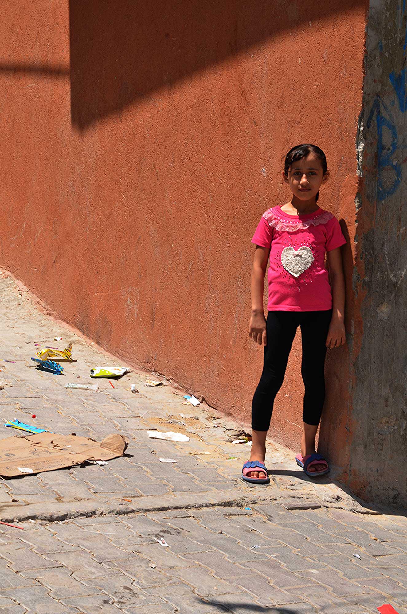 A girl stands in the street in Shejaiya, Gaza, where relief is necessary.