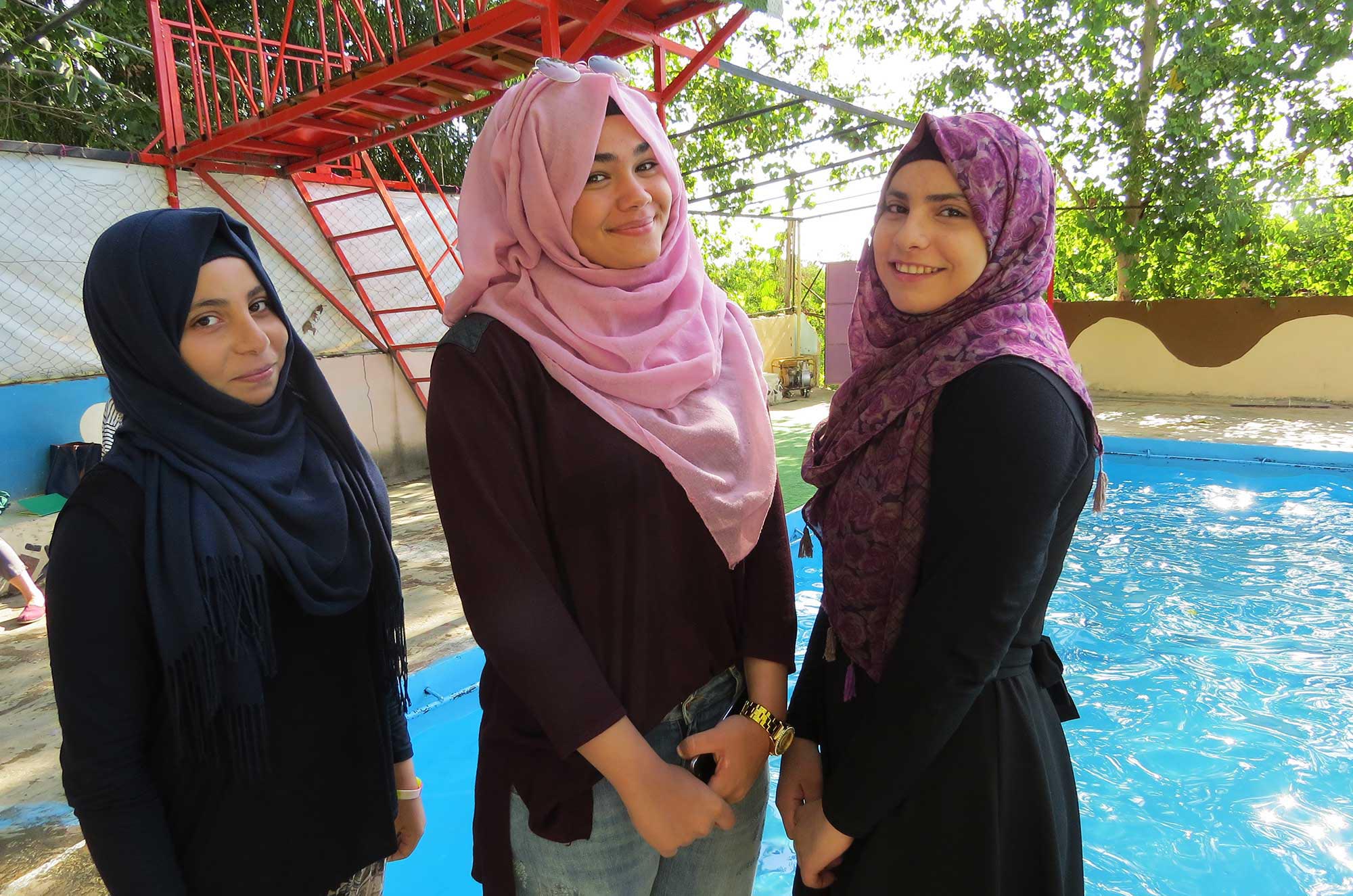 Rawan, center, is the young teacher of girls’ swim classes. Lina and Mona, beside her, are two of her students.