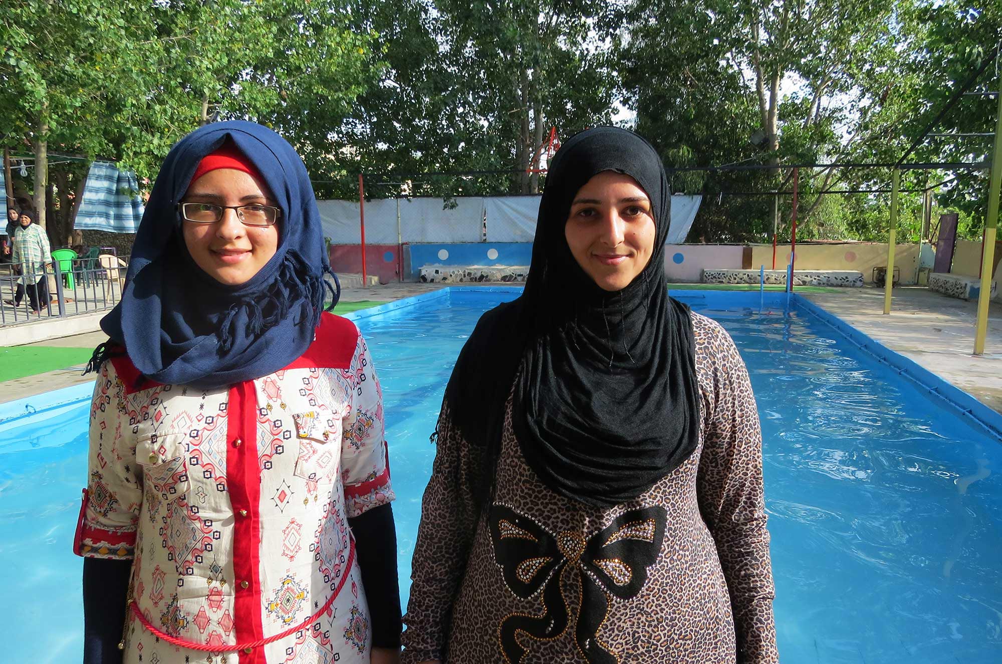 Twenty-five year-old Hanaa Hilal poses poolside with her friend at Hittine Swimming Club.