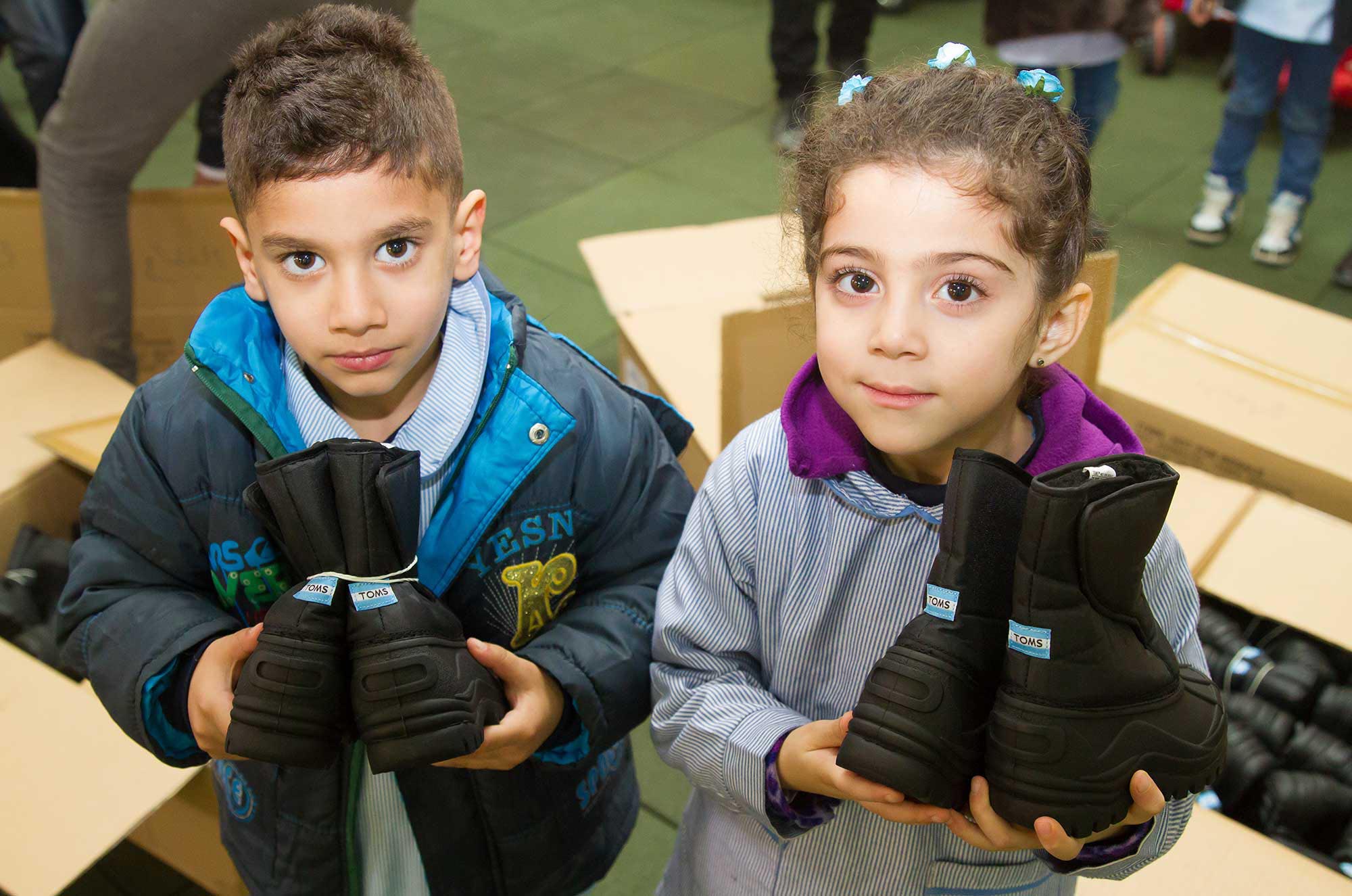 Palestinian and Syrian refugee children at Wavel camp preschool received new winter boots from TOMS.