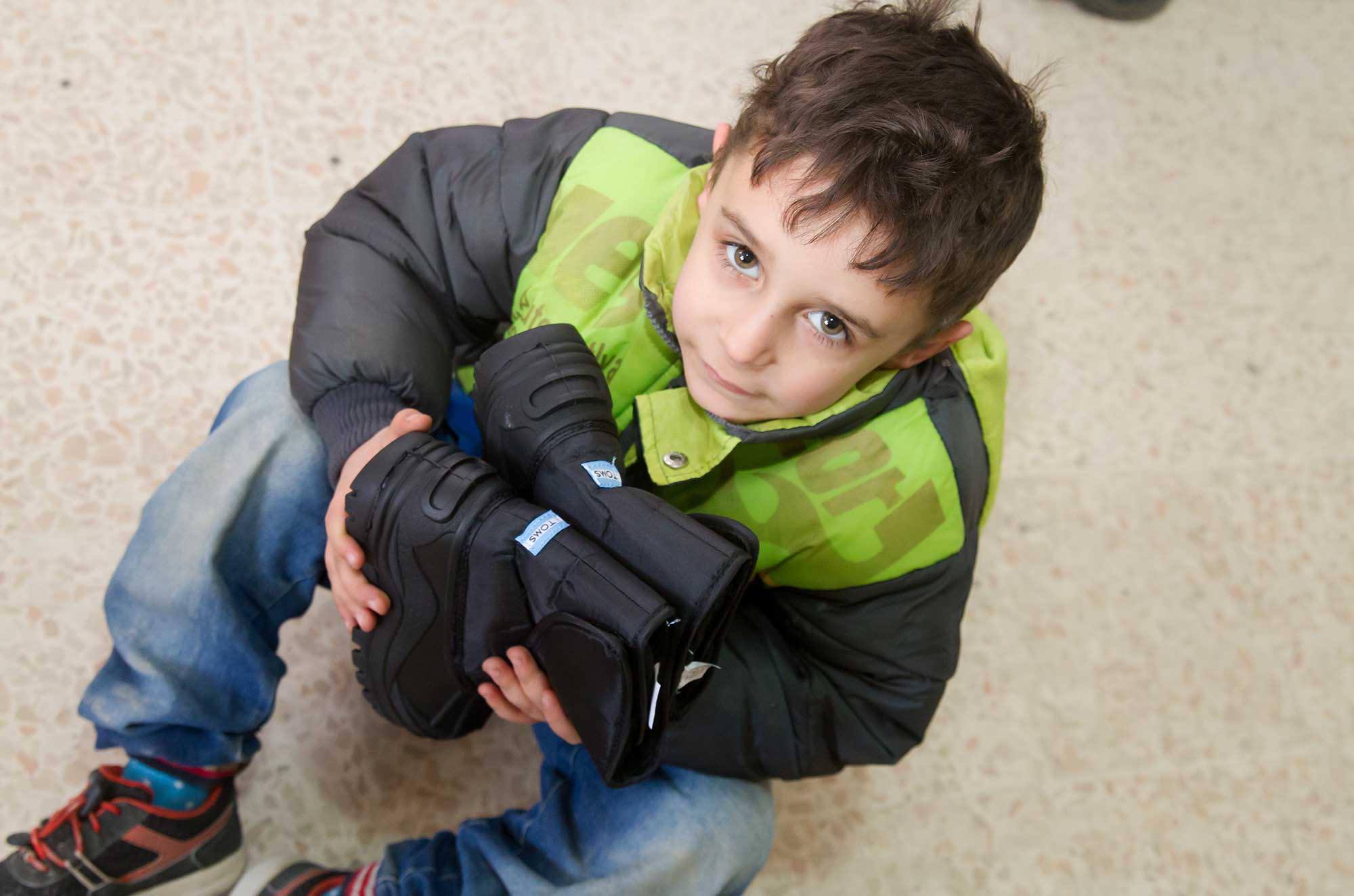 Palestinian and Syrian refugee children at Wavel camp preschool received new winter boots from TOMS.