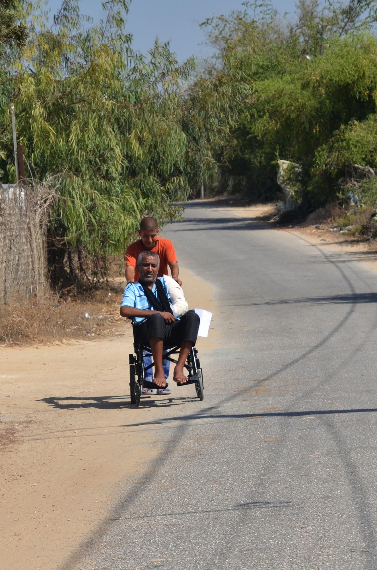 wheels Fathi's son takes him around their village on his new wheelchair.