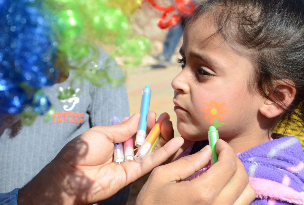Girl gets her face painted at the opening of the new park Anera built in her West Bank community.