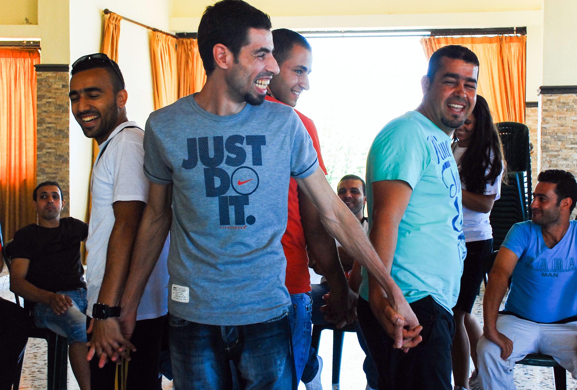 24 soccer coaches use group games to learn how to resolve their differences at Anera's conflict resolution workshop in Lebanon.