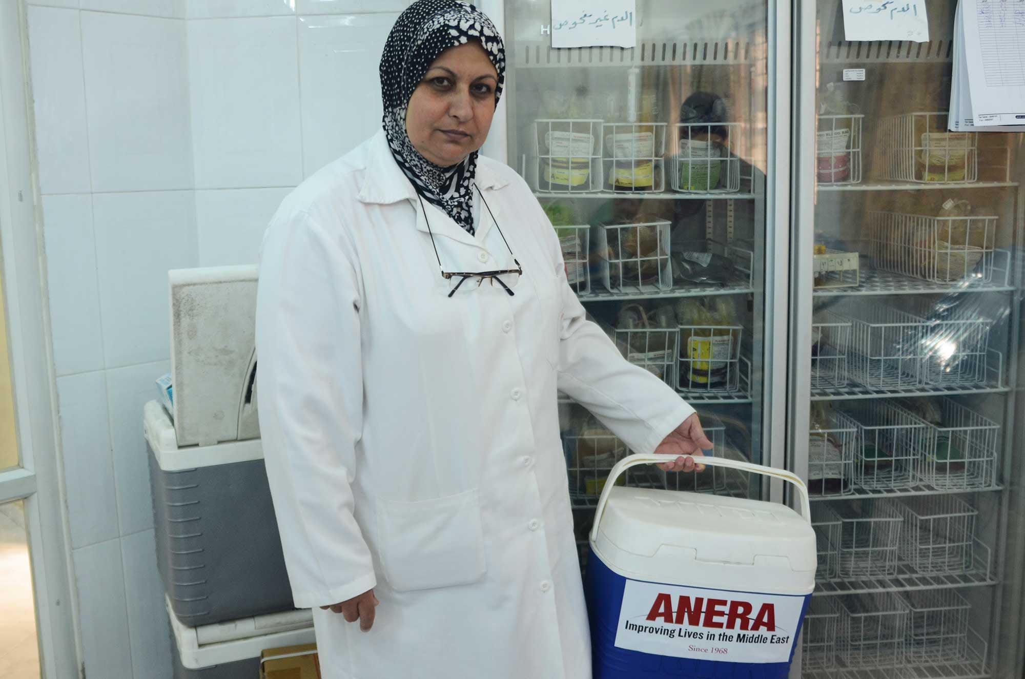 A nurse at the blood bank carries pints of blood in this new cooling container.