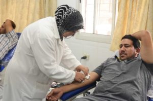 A man donates his blood at the Gaza Blood Bank Society, where Anera recently provided vital new equipment.