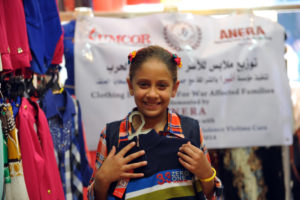 A young Gaza girl, displaced by war, shops for winter clothes with Anera clothing vouchers.