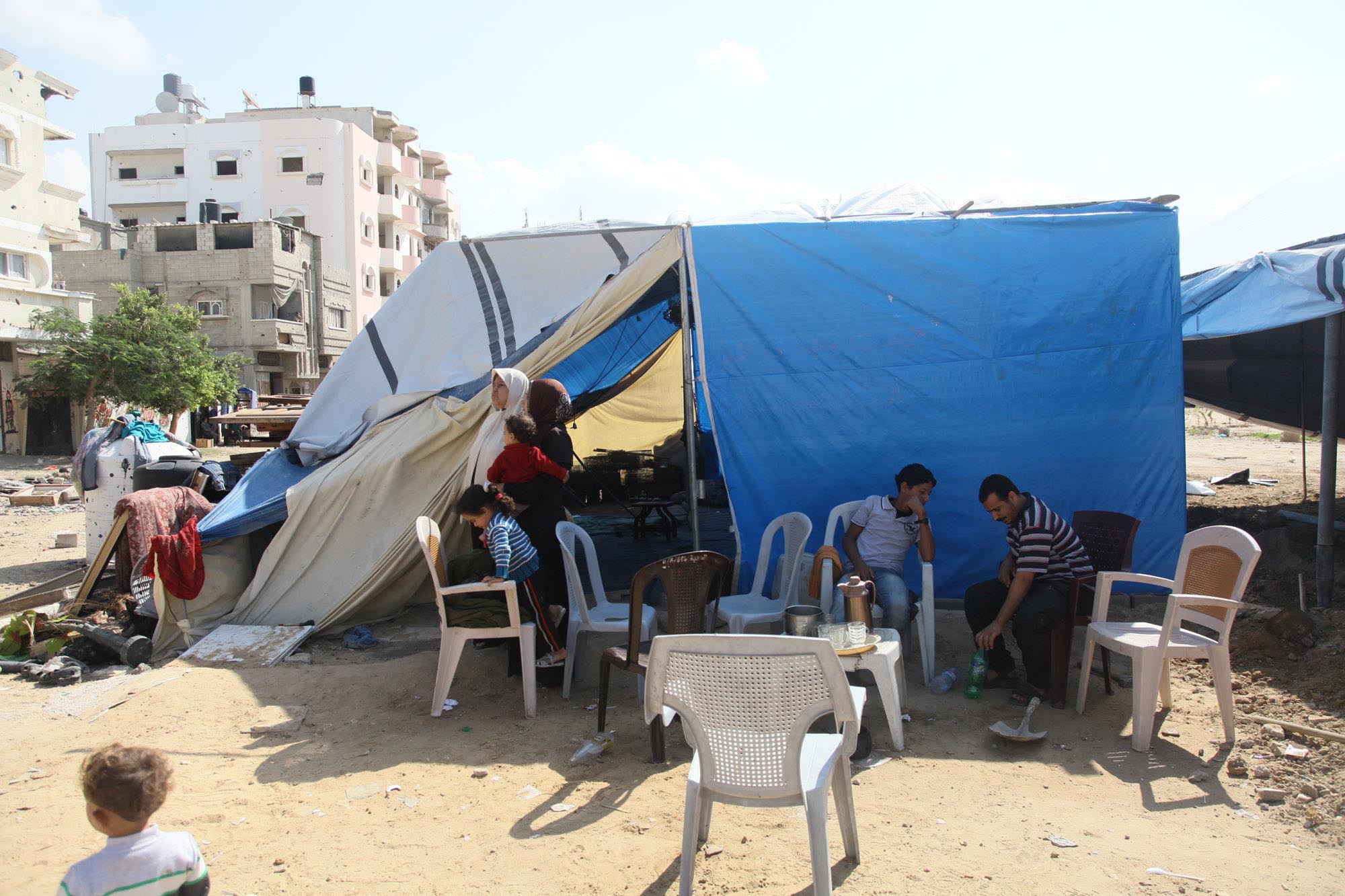 Gaza homeless like Siham and her family are living in makeshift tents next to rubble of their homes.