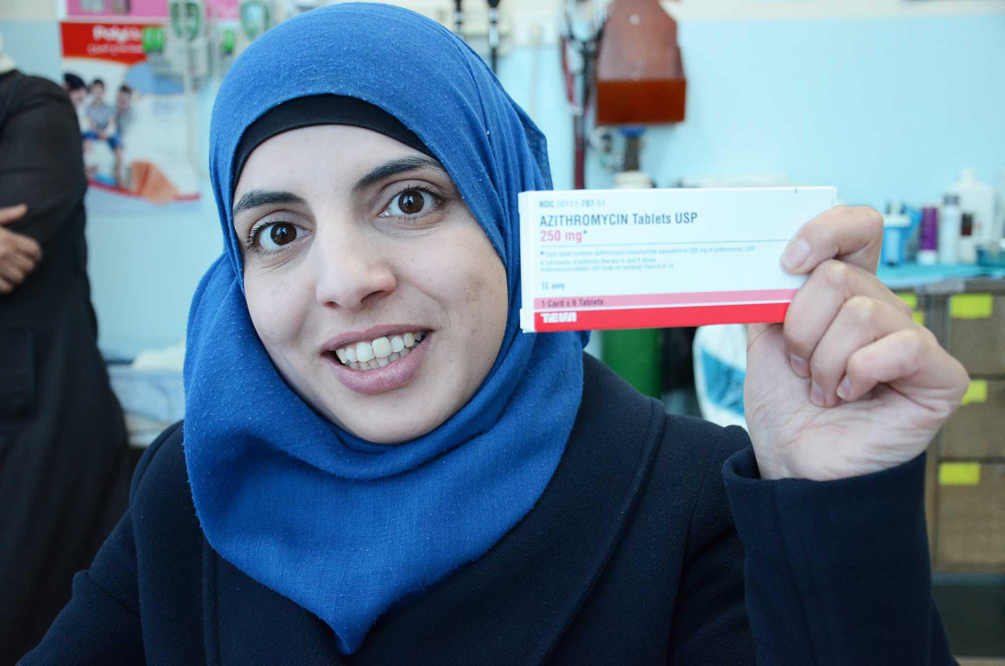 Suzanne, a patient at the clinic, receives antibiotics and a health lesson during her visit.