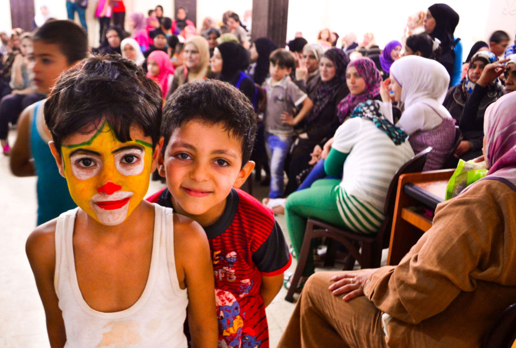 Kids have fun getting their faces painted at Anera's health education fair in Burj El Burajneh camp, Lebanon.