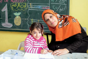 In her Gaza preschool classroom, Inshirah is very attentive to her children, like Aisha who is studying English.