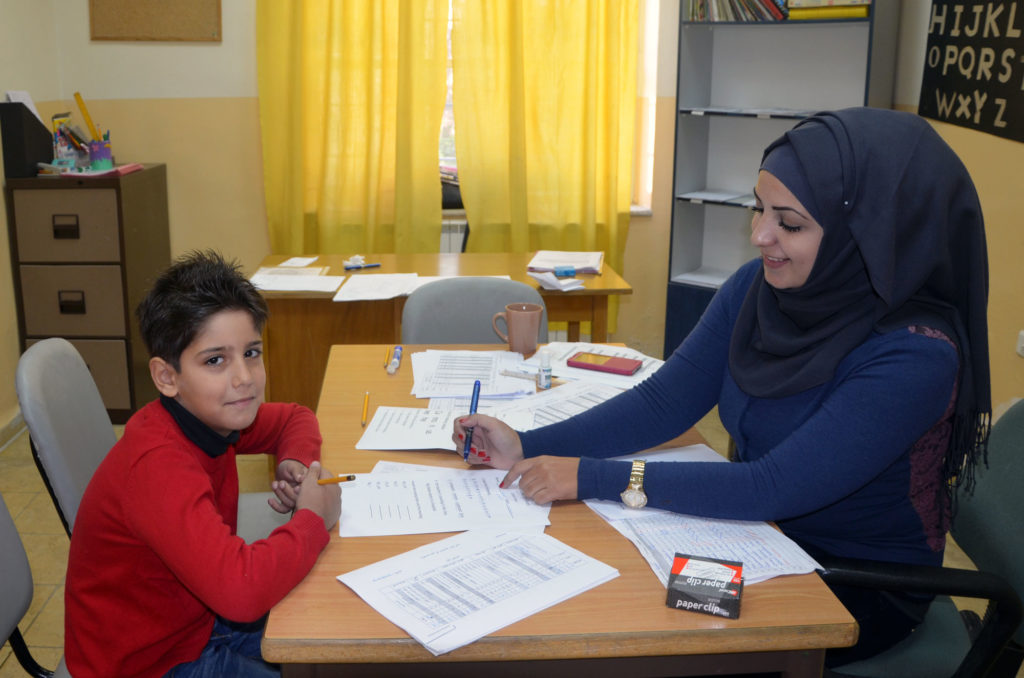 A student gets help with his homework at a child health center in Jerusalem.