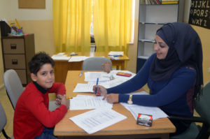 A student gets help with his homework at a child health center in Jerusalem.