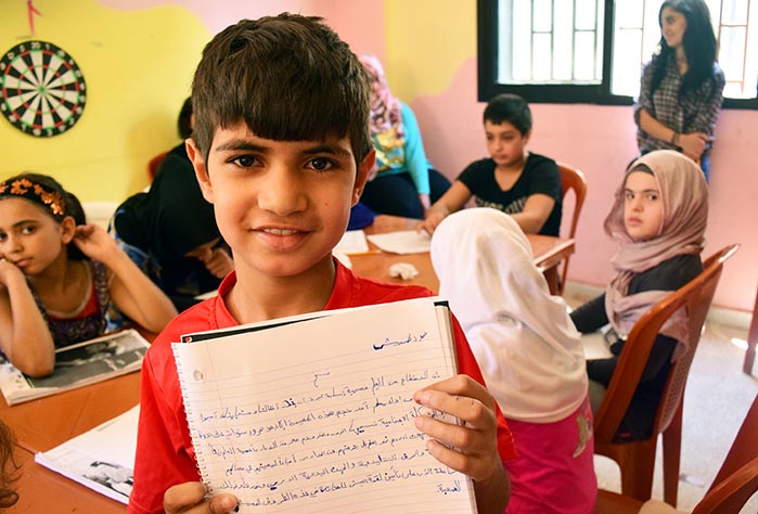 A refugee student practices his Arabic in one of Anera’s remedial education classes.