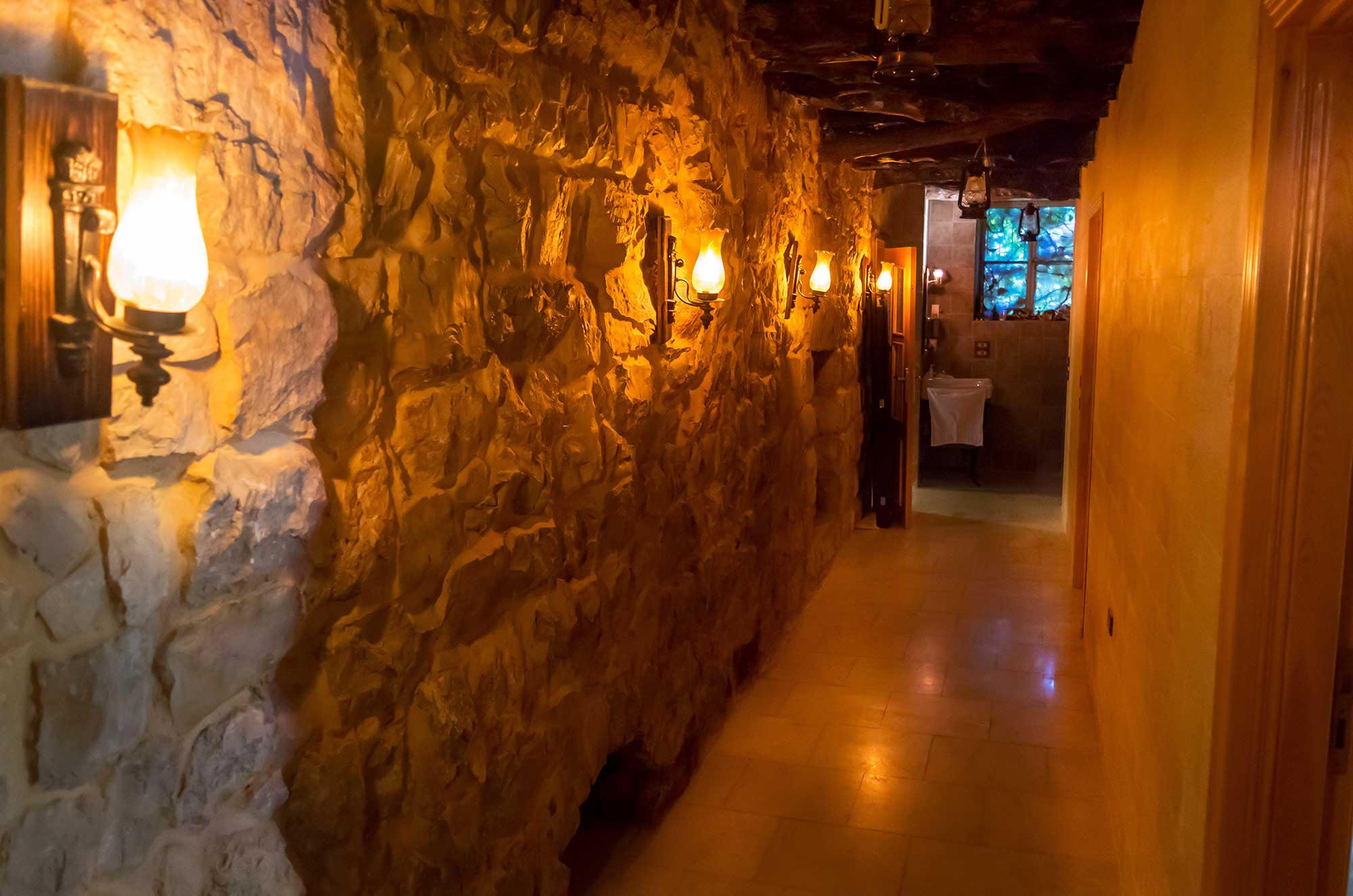 This stone wall corridor reflects the traditional elegance of the house.