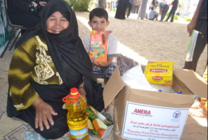 Gaza grandmother Darweesha and grandson Alaa' are delighted with their Ramadan food parcel distributed by Anera.