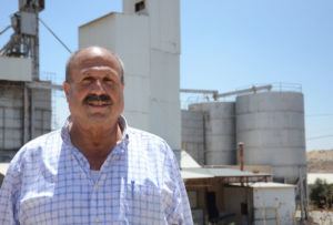 Manager Othman Al Deek stands in front of poultry co-op Anera built in Ramallah 35 years ago.