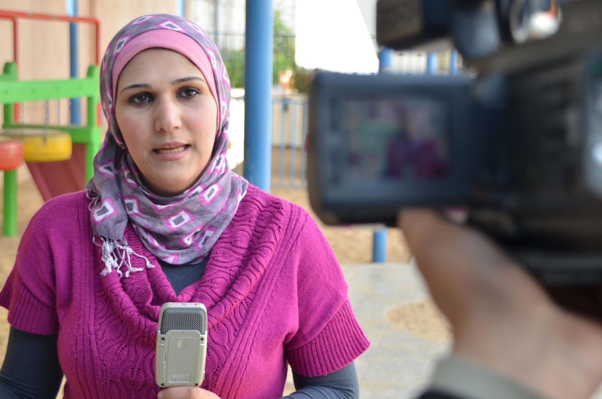 Anera's media relations officer in Gaza covering a story.