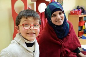 Mohammad Dajani and his teacher Reem Zahaikeh spend time together at the Spafford Center.
