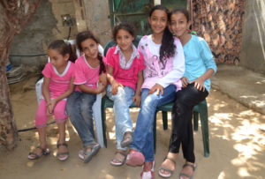 Five sisters enjoy their new Crocs shoes, just some of 8,000 pairs delivered by Anera to needy families across Gaza.