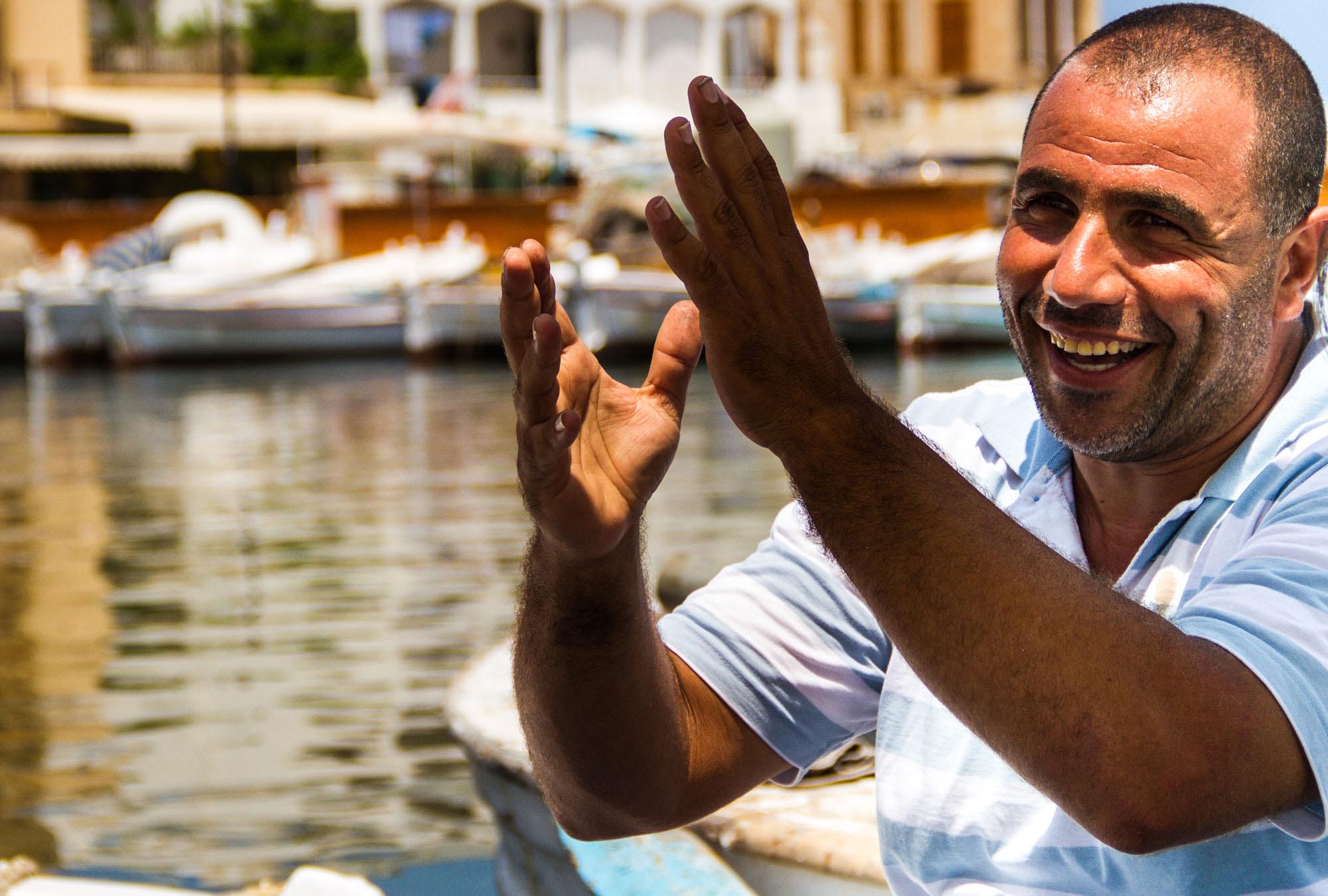 Small-Loans-Help--Business-in-Lebanon Bilal sits in his fishing boat in Tyre's port, Lebanon. The $1,000 grant he received from Anera after the 2006 war allowed him to wait for the situation to return to normal.