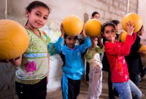 The girls in Beddawi Palestinian Camp in Lebanon are thrilled to get Anera's soccer balls and the opportunity to play.