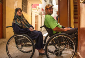 Refugees Fatiha and Mohammad in a Palestinian refugee camp use their wheelchairs from Anera.