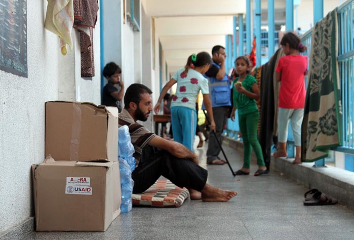 A Gaza family sheltering at a UN school gets hygiene kits and water.