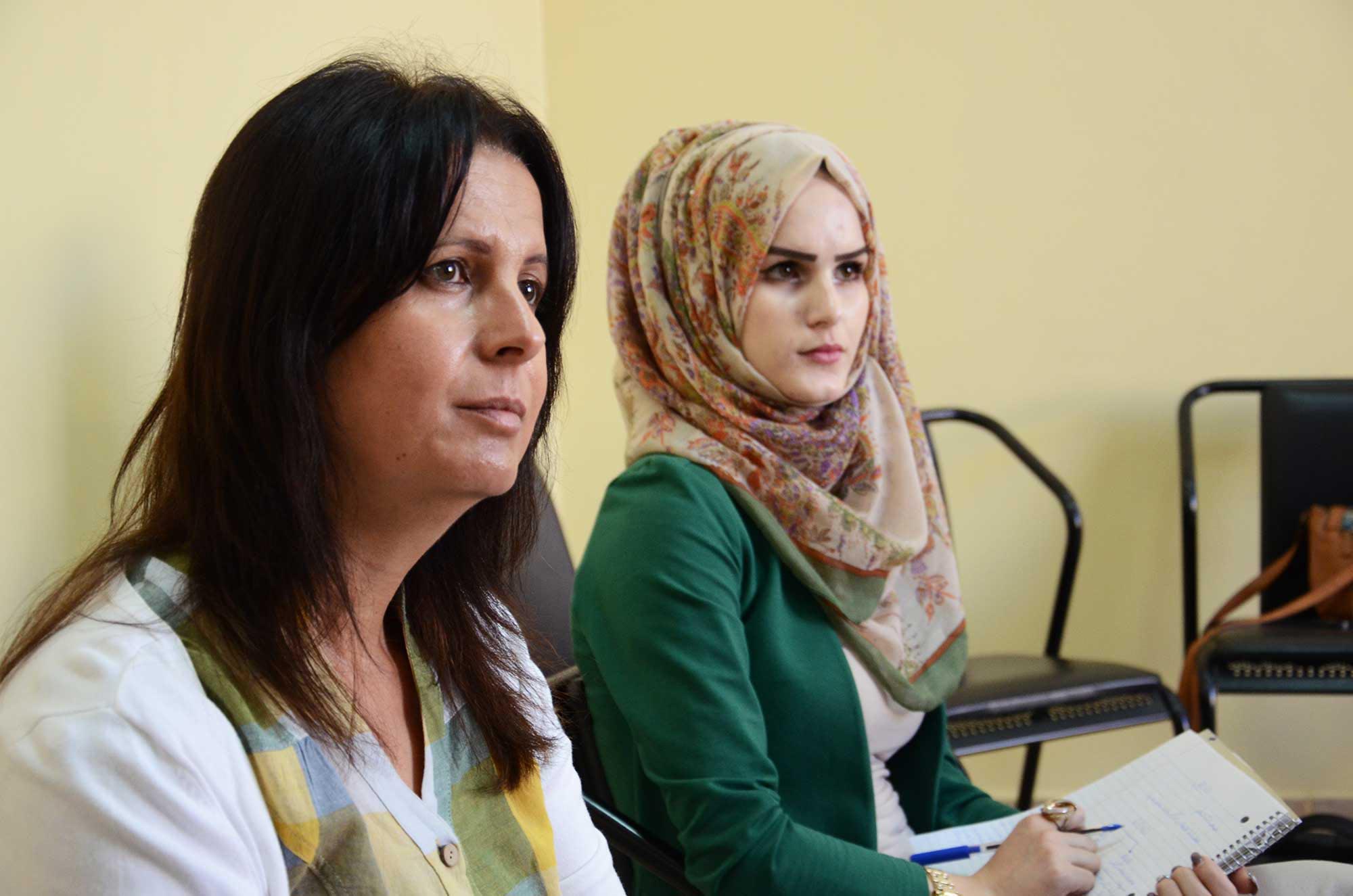 Manal (left) trains teachers to support Palestinian children with ADD/ADHD.