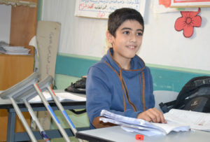Ten-year-old Abed El-Azeez leans his new Anera-donated crutches against his desk at school in Gaza.