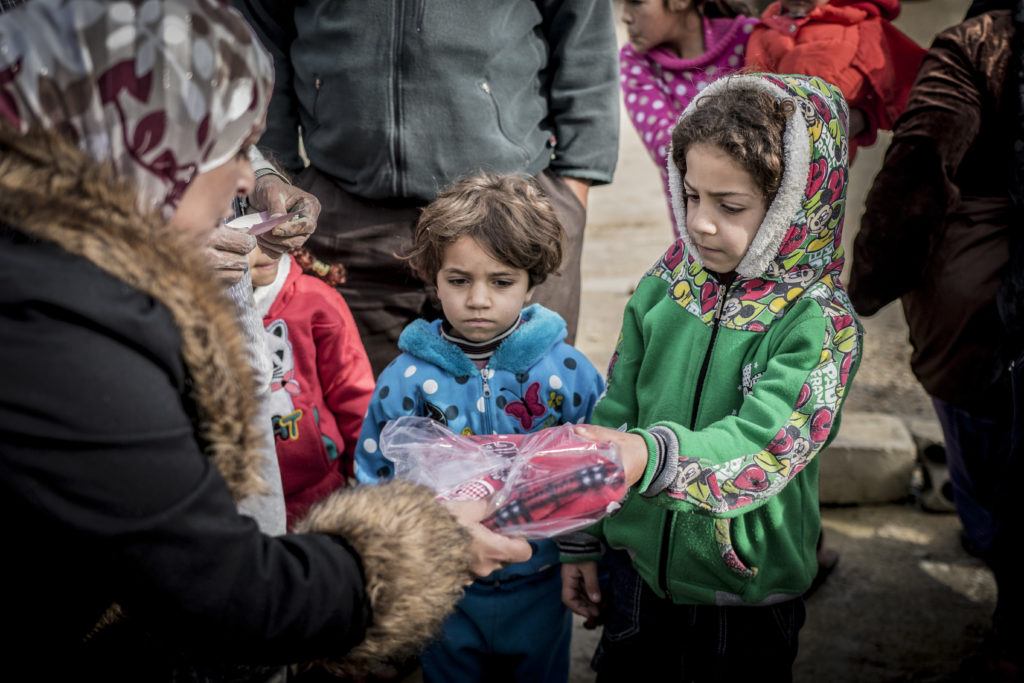 Palestinian refugees from Syria in Lebanon get warm quilts and clothes.