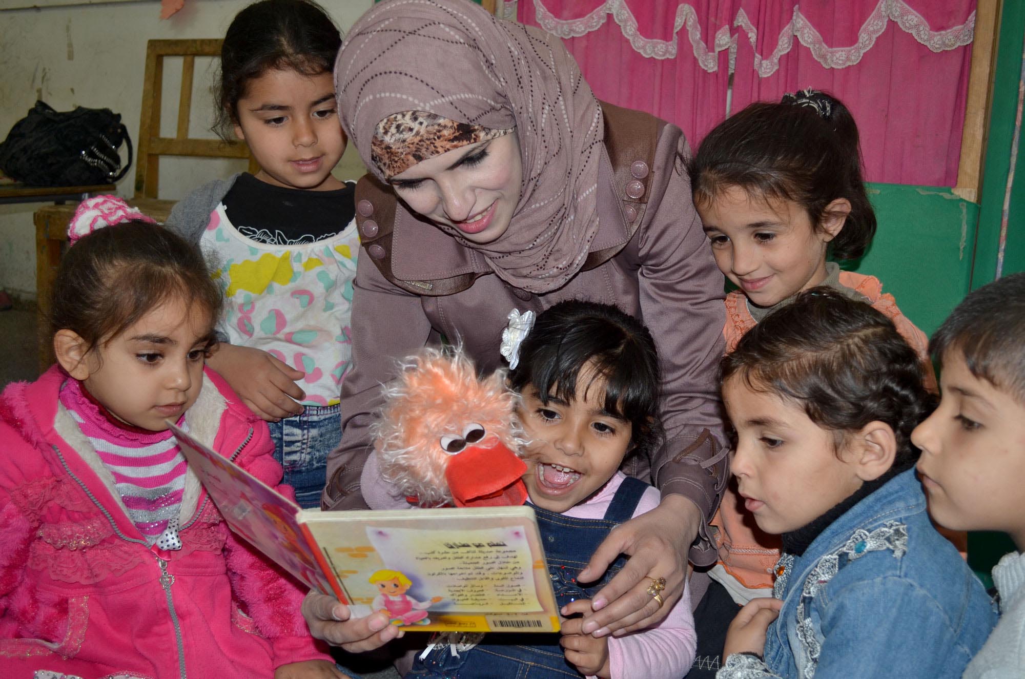 Gaza preschool teacher Mona Abu Jurai uses colorful puppets and other props she learned about in Anera's Right Start! training program.