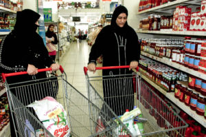 Palestinian mothers who fled from the Syrian war go grocery shopping with aid vouchers from Anera