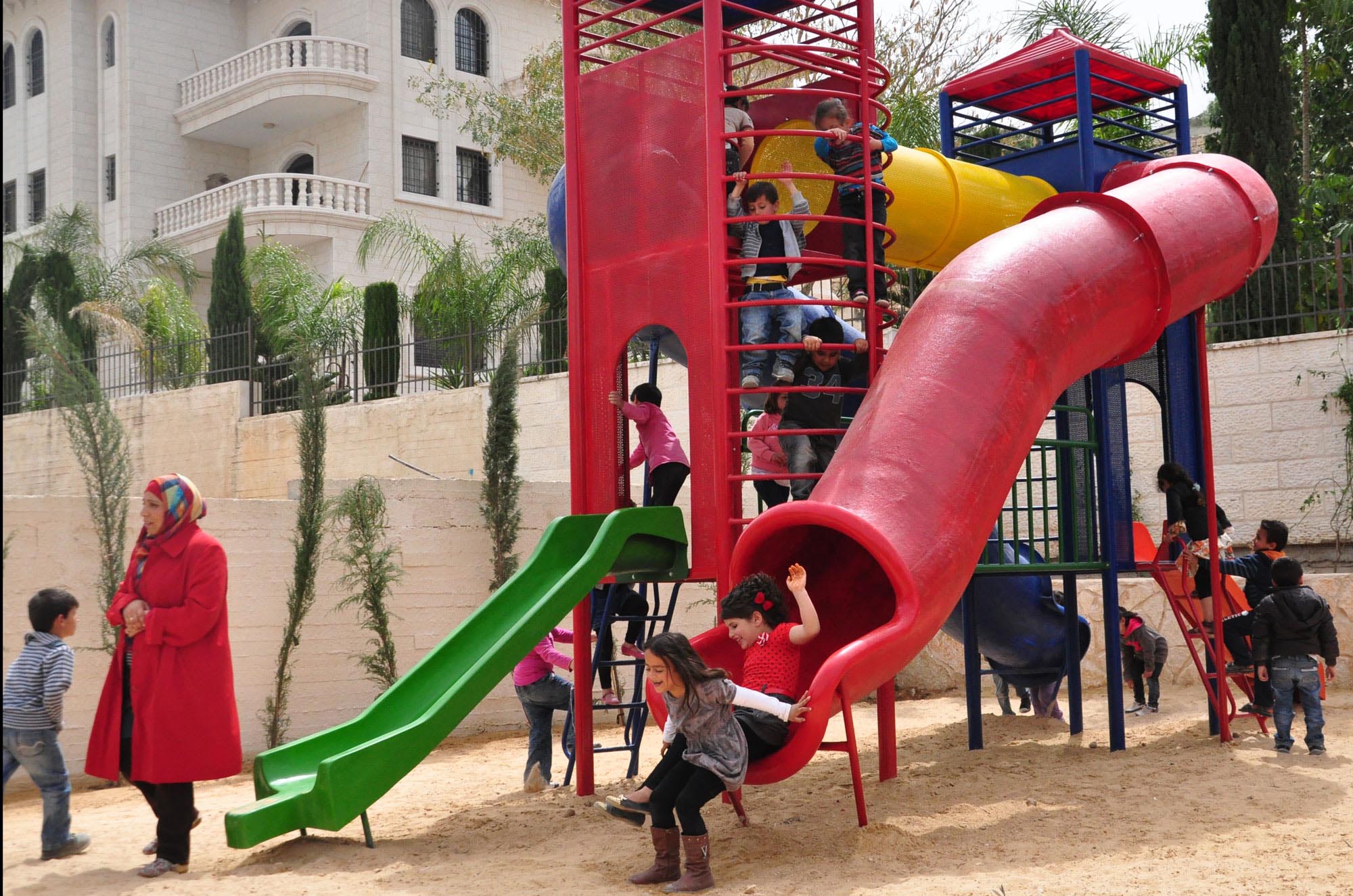 Bright red and green slide attract children of Ras Karkar in new public park Anera built in the West Bank village.
