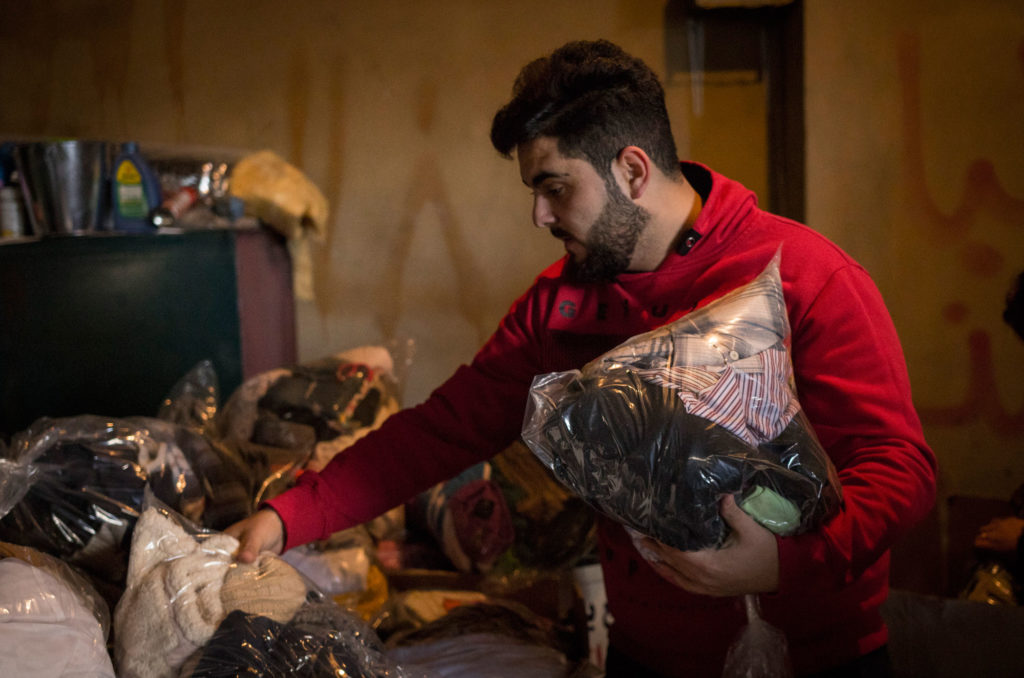 A teen sorts winter relief items for Syrian refugees in the Bekaa.