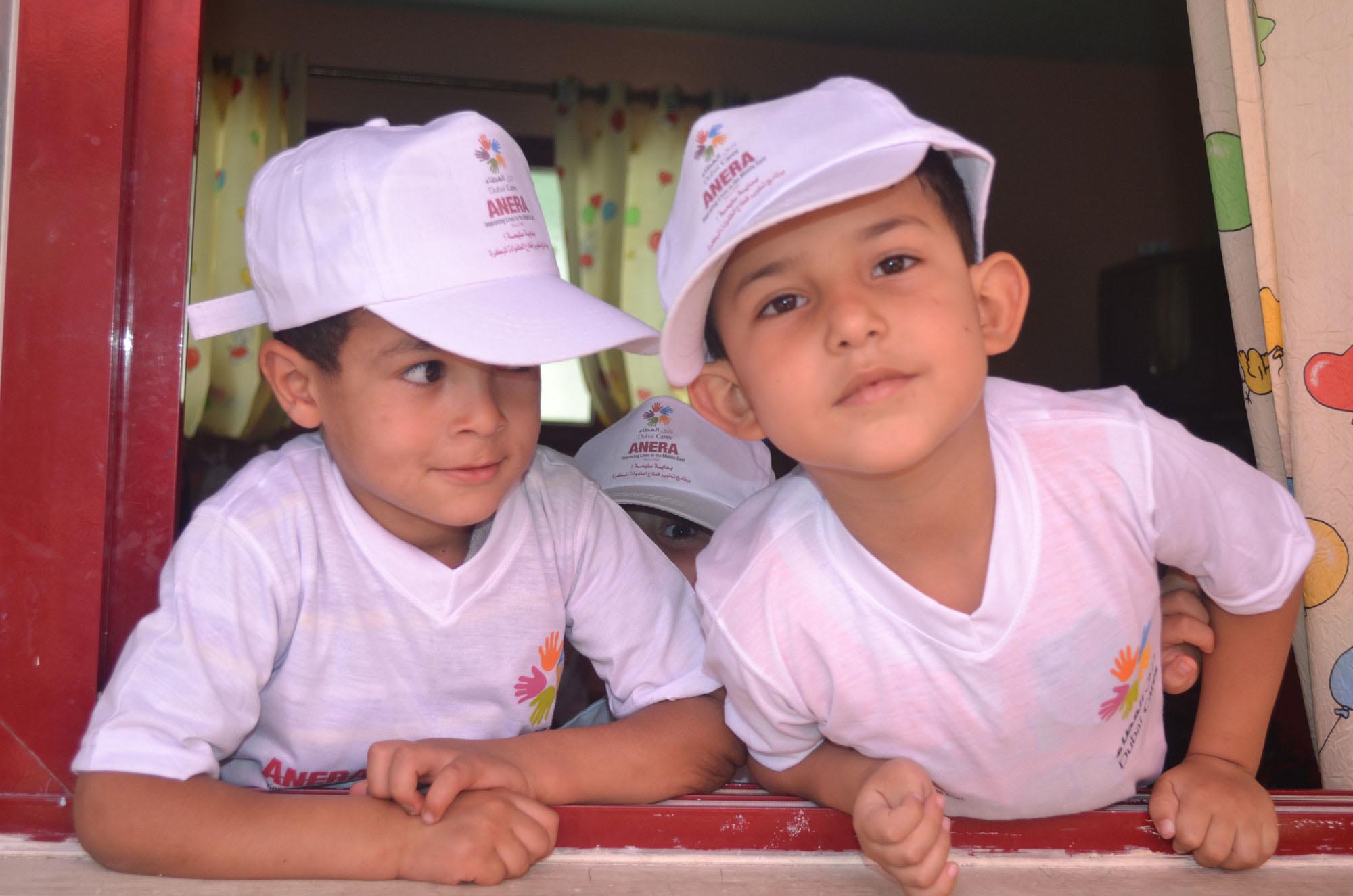 Two Gaza boys play in their new camp t-shirts at one of Anera’s summer camps at a preschool in northern Gaza.