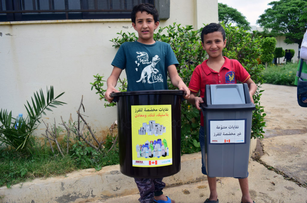 As part of the refugee camp recycling project, each household gets bins to sort trash from recyclables.