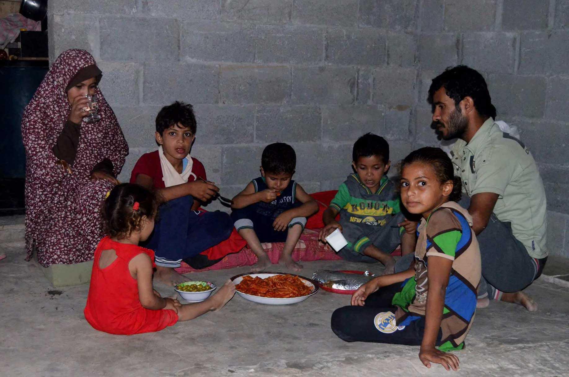 Poor family celebrates Ramadan with donated food parcels in Gaza.