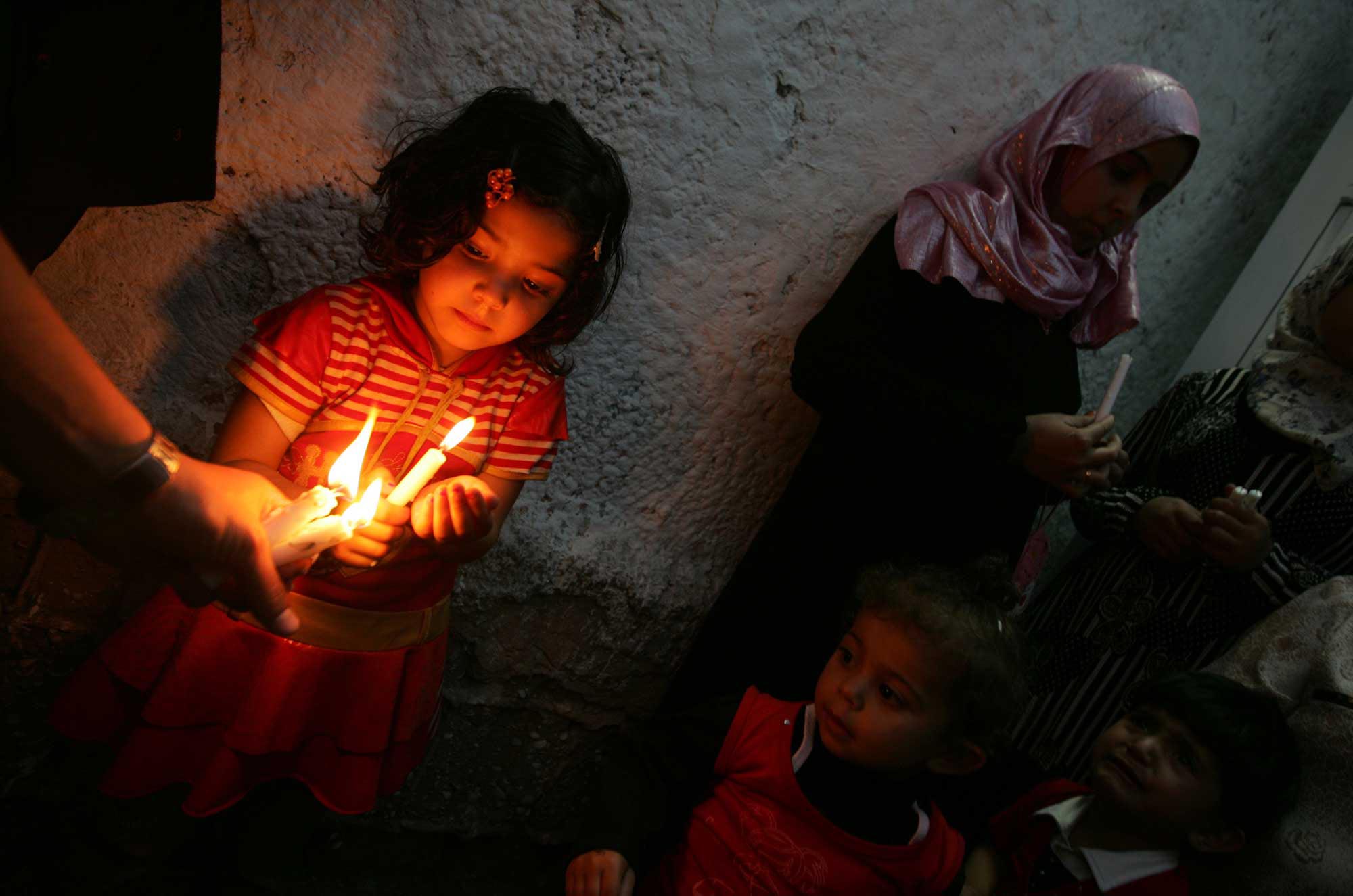 Gaza electricity crisis makes families live by candlelight.