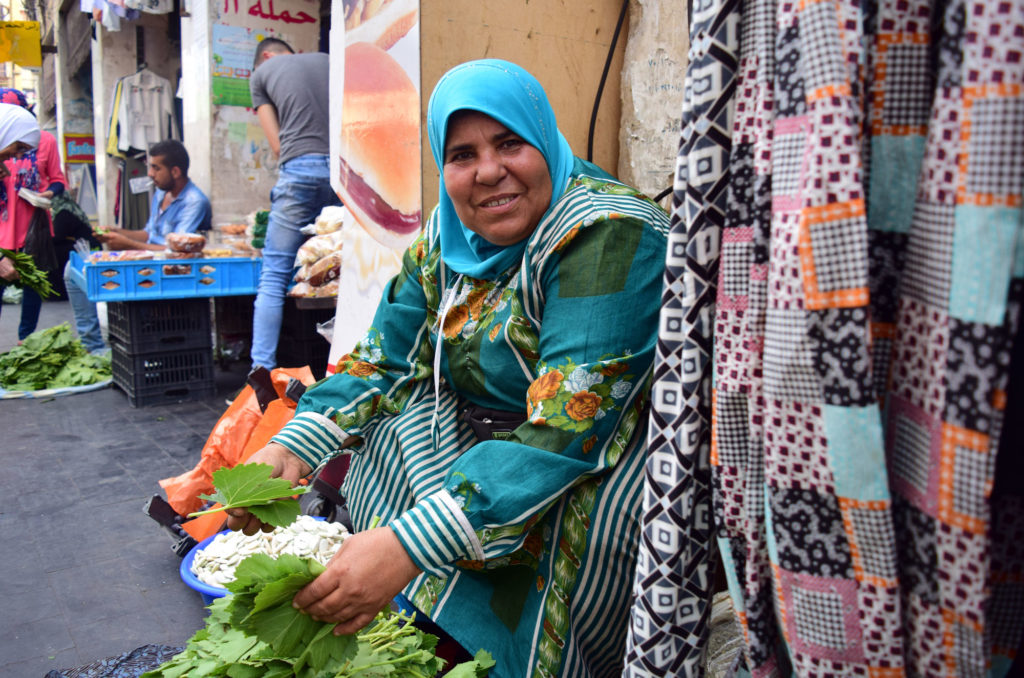 Diba, a Lebanese farmer, sells greens at the local market