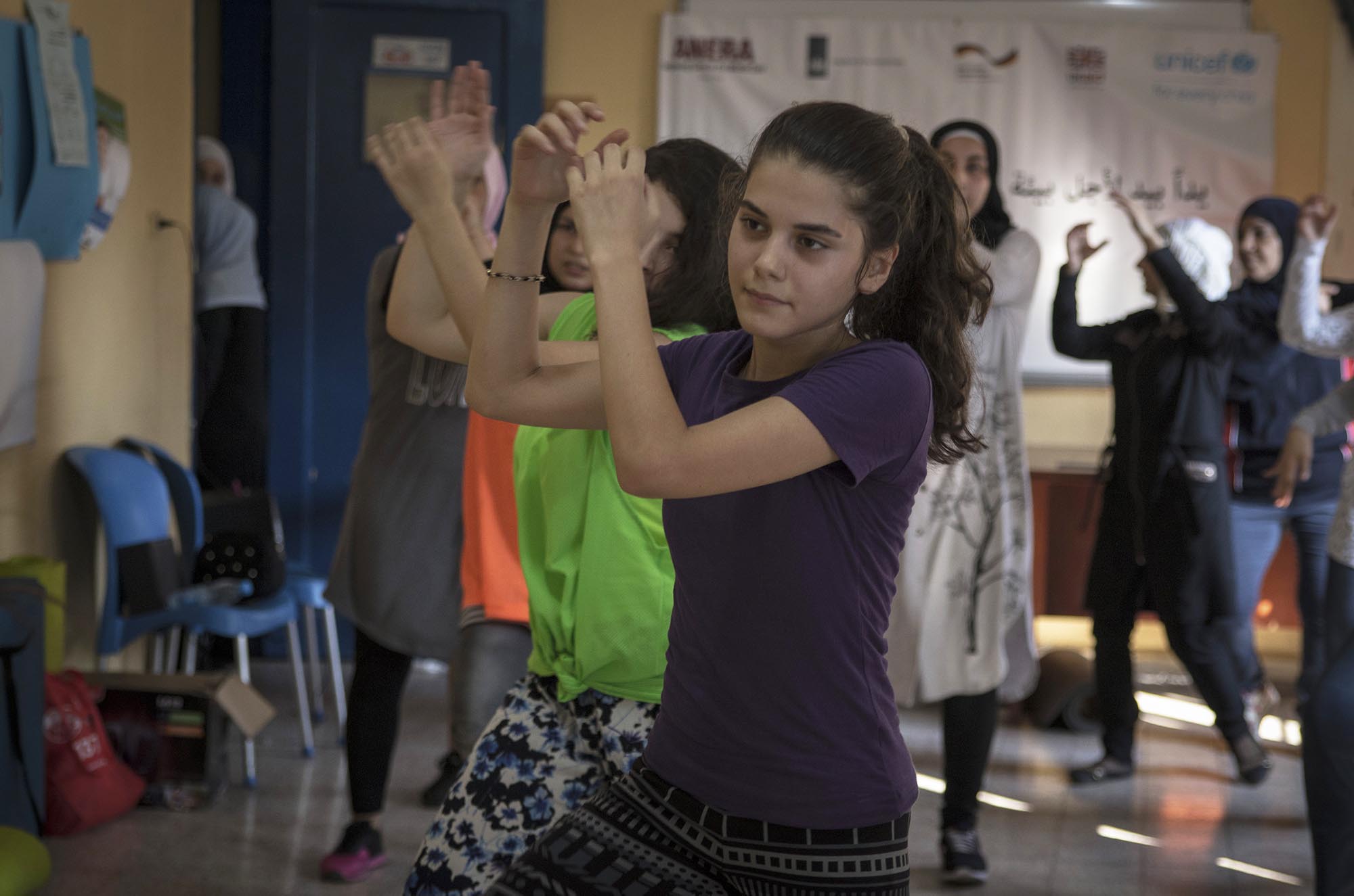 Refugee girl partakes in zumba class in Lebanon.