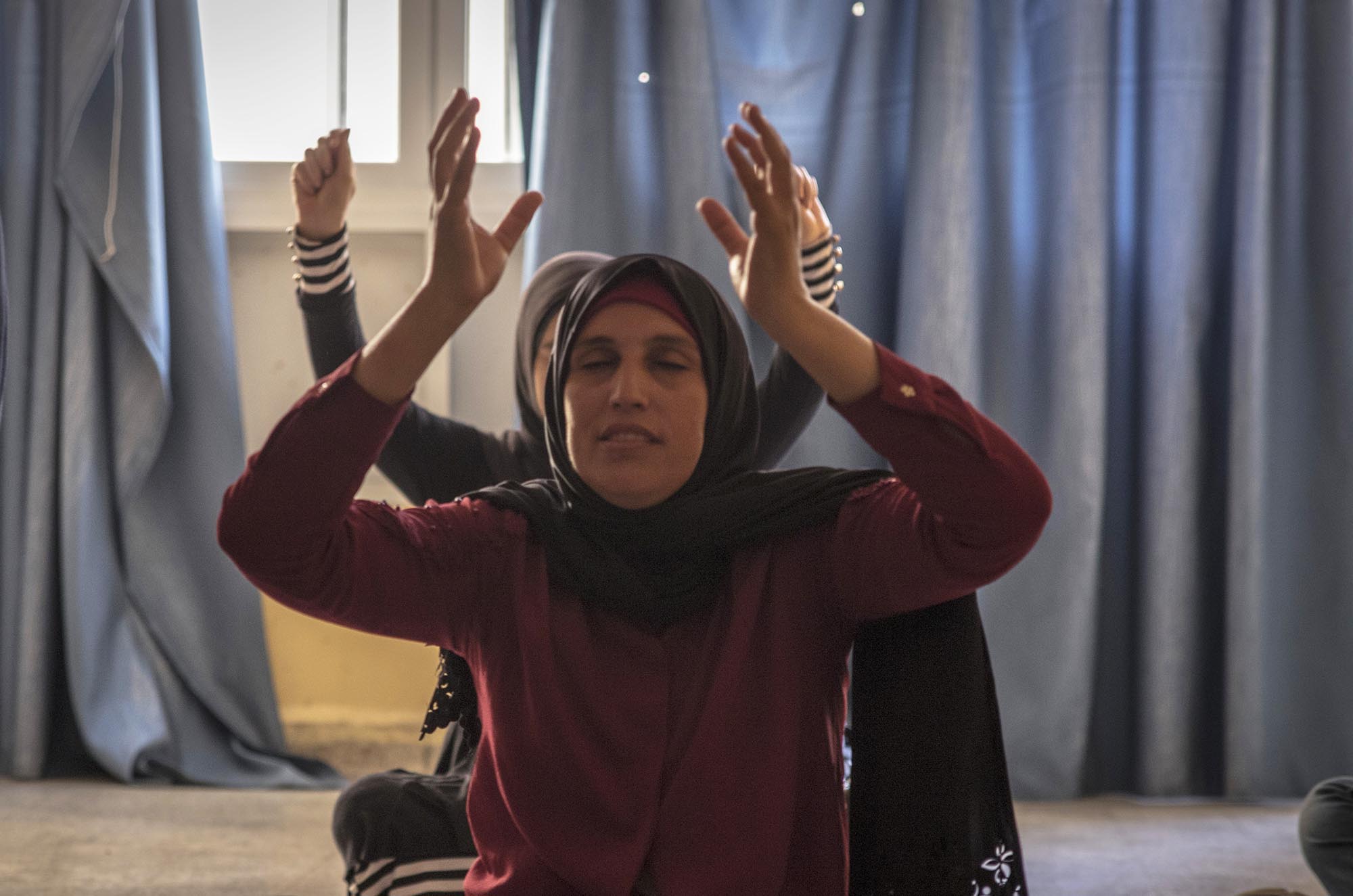15_Yoga_AlMmarkazAlWatani_24817-EDIT A young refugee woman takes yoga class in Lebanon.