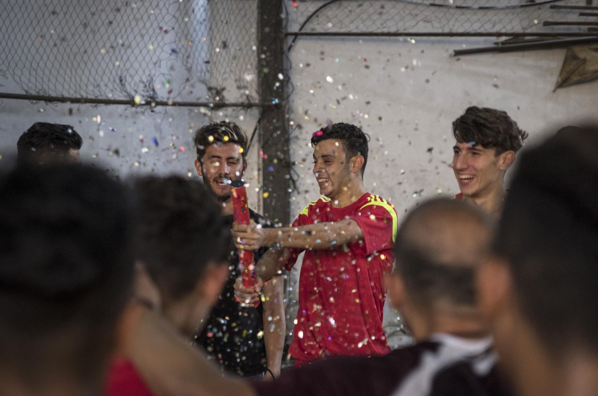 Syrian and Palestinian youth celebrate winning a championship soccer game.