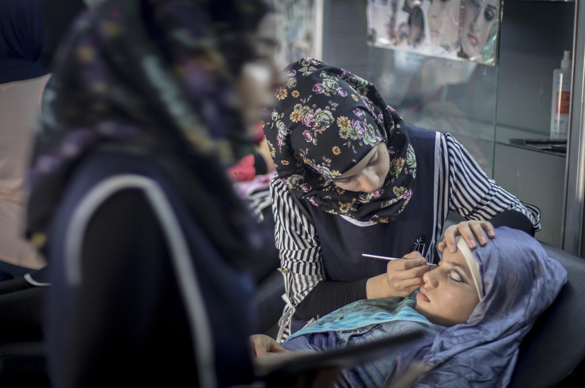 Syrian and Palestinian refugee youth enroll in a makeup course in Lebanon.