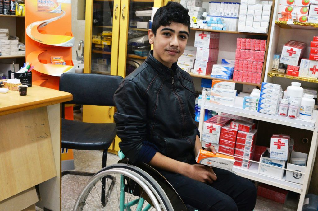 A young Palestinian boy picks up his medication at a Gaza clinic supplied by Anera's in-kind program.