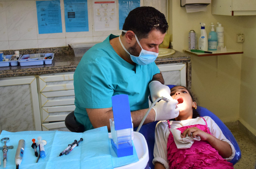 Dalaa undergoes dental treatment at a health care center in Lebanon.
