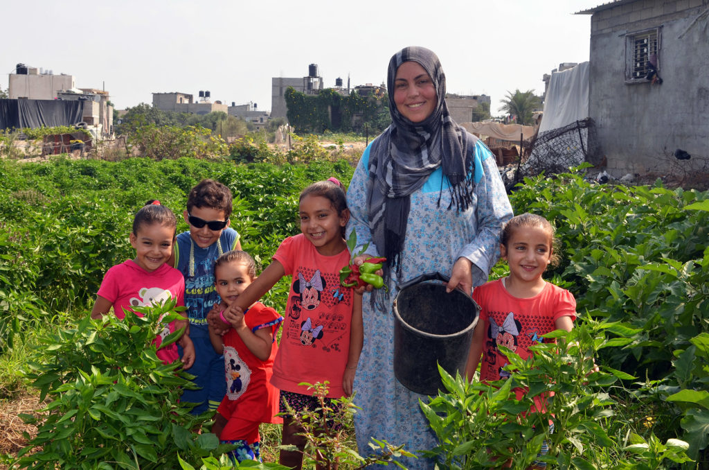 Khatami stands with her children inside the farm in Gaza