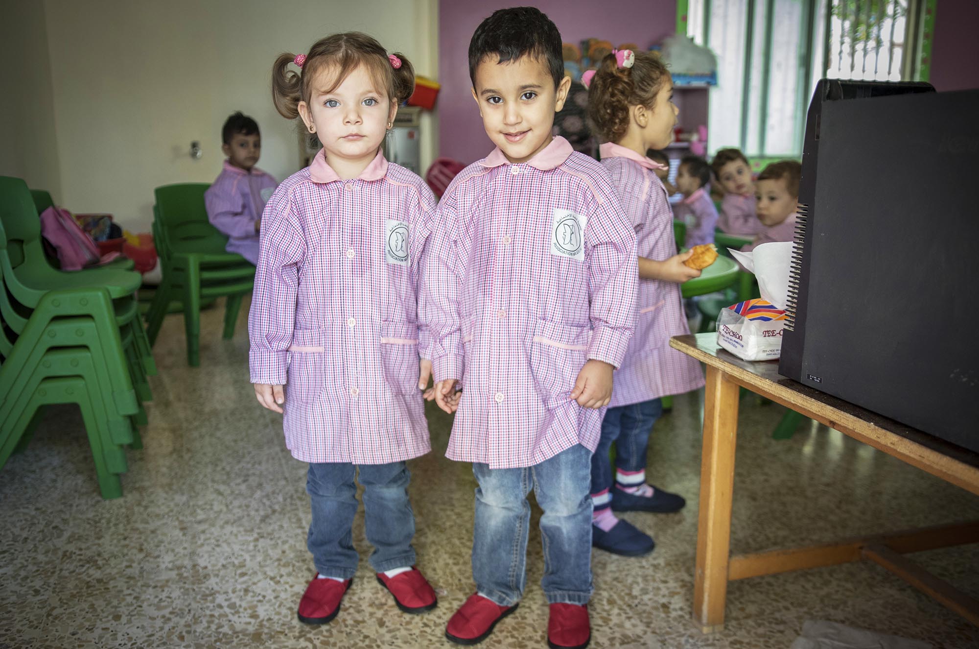 Preschoolers in Beddawi Camp in Lebanon picks up brand new TOMS shoes.