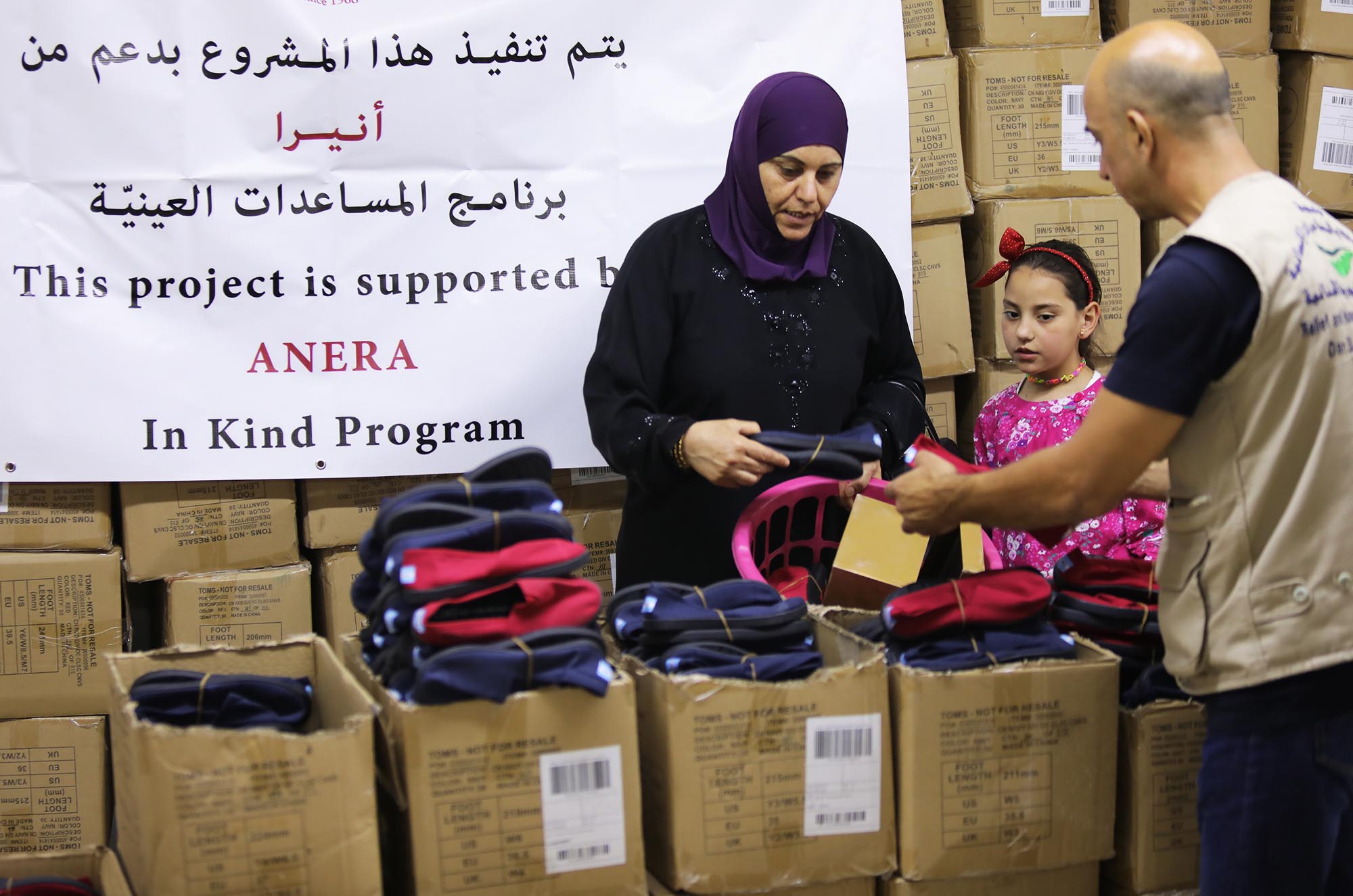 A mother and child receive new TOMS shoes in Lebanon.