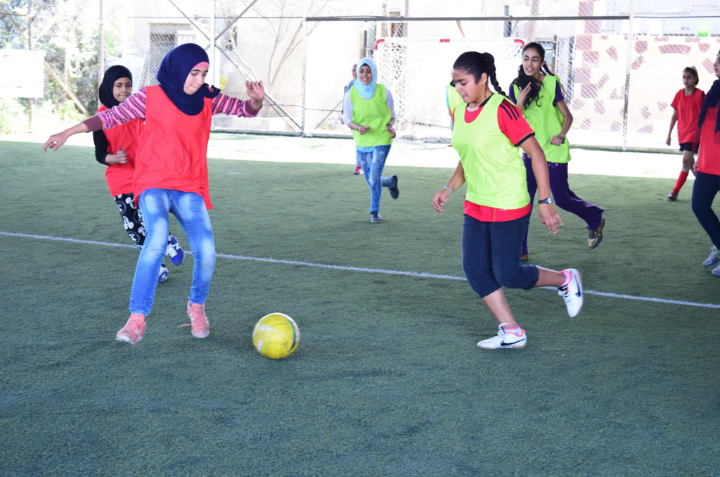 Girls during a football life skills through sports learning course
